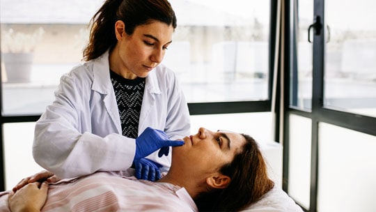 Doctor examining patient in consultation
